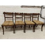 A set of four mahogany Scottish Regency side chairs with elaborately carved top rails, reeded back