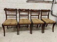 A set of four mahogany Scottish Regency side chairs with elaborately carved top rails, reeded back