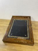 A 19thc rosewood veneered writing slope with brass plaque to top and brass bound, interior with