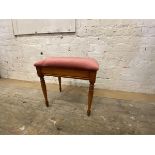 A stained beech stool with upholstered seat on turned supports, labelled Bradley, measures 52cm x
