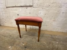 A stained beech stool with upholstered seat on turned supports, labelled Bradley, measures 52cm x