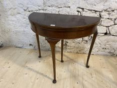 A Georgian style mahogany and walnut demi lune card table, c1930, fold-over top with baize lined