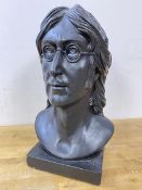 A plaster bust of John Lennon, painted black, on square base, measures 35cm high