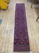 Meshwni runner with six diamonds to field within geometric border and overall motif, (275cm x 60cm)
