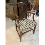 A 19thc mahogany open armchair with the arched top rail over vase shaped pierced splat, curved arms,
