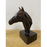 A metal sculpture of horse head on rectangular base, measures 19cm high