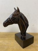 A metal sculpture of horse head on rectangular base, measures 19cm high