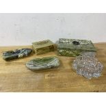 A pair of green stone ash trays in the form of row boats,