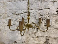 A brass five branch chandelier with scrolled arms and faux candles, (25cm x 59cm)