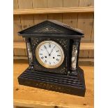 An Edwardian slate mantel clock of architectural form, marble columns and inlay to pediment,