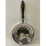 A white metal plated pan with gadrooned edge and turned wooden handle, measures 6cm x 55cm x 28cm