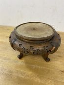 A Chinese circular stand with pierced apron on four C scroll supports, likely a lamp base, (12cm x