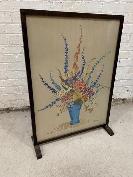 A 1930's / 40's floral embroidered panel within glazed fire screen,