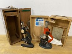Two vintage microscopes with original boxes, one box with label Studio Mikroskope, and a copy of The