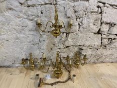 A pair of Dutch style brass three branch chandeliers with scrolled arms and faux candles, measures