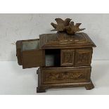 A c1900's Swiss treen jewellery box, the hinged lid with two doves, opens to two fold out