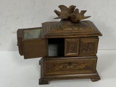 A c1900's Swiss treen jewellery box, the hinged lid with two doves, opens to two fold out