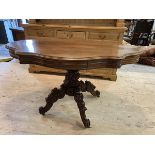 A Victorian mahogany centre table, the undulating top with two drawers to long ends, moulded edge on