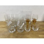 A group of glasses including two wine glasses with amber glass stems,