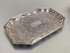 A silver card tray, Edinburgh 2012, of rectangular form, with cut-off corners, chased to the well