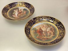 A pair of large Vienna style porcelain plates, one painted to the well with Perseus being