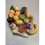 A collection of ceramic and stone realistically modelled fruit and vegetables, some stamped with (