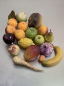 A collection of ceramic and stone realistically modelled fruit and vegetables, some stamped with (