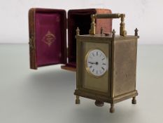 A cased miniature carriage clock, c. 1900, the white enamel dial with Roman numerals within a
