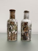 A pair of late Victorian decalcomania bottles, of cylindrical form, with characteristic decoration
