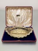 An Edwardian silver-gilt cake basket, Sutherland & Roden, Sheffield 1905, of oval form, with pierced