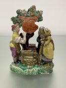 A Staffordshire pearlware Gretna Green figure group, c. 1820, the couple standing before a