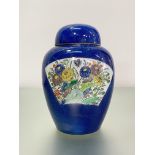 A Chinese porcelain jar and cover, painted with a pair of fan-shaped cartouches, enamel painted in a