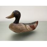 Folk Art: a painted wooden decoy duck, with red-tipped wings. Length 30.5cm