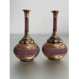 A pair of Bohemian cased cranberry glass vases, 19th century, of flask form, cut and gilt-painted