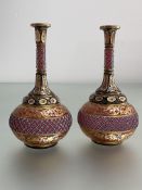 A pair of Bohemian cased cranberry glass vases, 19th century, of flask form, cut and gilt-painted