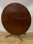 A Regency design mahogany tilt top dining table, the circular top with reeded edge over a single