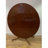 A Regency design mahogany tilt top dining table, the circular top with reeded edge over a single