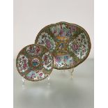 A 19th century Canton famille rose platter, of shaped oval form, painted with alternating figural