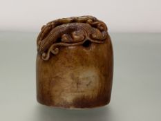 A Chinese soapstone seal, oval, carved in relief with a dragon, and bearing an inscription to one