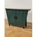 A Chinese side cabinet, late 20th century, the projecting top over two drawers and twin doors