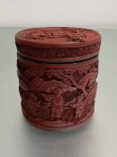 A Chinese cinnabar lacquer box, 19th century, of cylindrical form, the lift-off cover and box