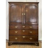 A George III oak linen press, late 18th century, the projecting cavetto cornice over two panelled