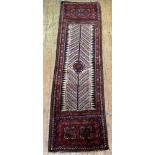 An Iranian runner rug, hand knotted thick wool pile, the ivory field centred with gul, with two