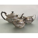 An Edwardian silver three piece tea service, Mappin & Webb, Sheffield 1907 and 1908, in the