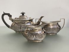 An Edwardian silver three piece tea service, Mappin & Webb, Sheffield 1907 and 1908, in the