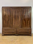 Whytock and Reid, a figured mahogany triple wardrobe, circa 1920, the cavetto moulded cornice with