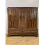 Whytock and Reid, a figured mahogany triple wardrobe, circa 1920, the cavetto moulded cornice with