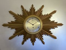 A vintage giltwood sunburst wall clock, the silvered dial with Roman numerals, Elliott key-wind