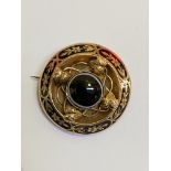 A late Victorian tiger's eye mourning brooch, mounted in yellow metal, circular, the central