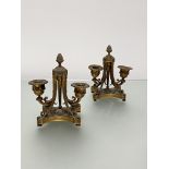 A pair of French gilt-bronze twin-light candelabra, in the Louis XVI taste, each shaped platform